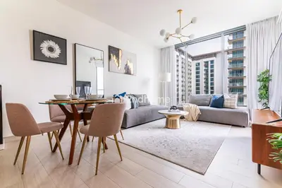 a living room with a table and a couch at Fully Equipped Residence at One Park Avenue in Dubai