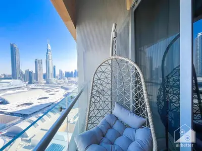 a swing on a balcony with a view of a city at Dubai Mall Downtown Luxury stay with Balcony & View in Dubai