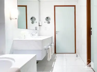 a white bathroom with a sink and a mirror at Dubai Mall Downtown Luxury stay with Balcony & View in Dubai