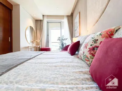 a bedroom with a large bed with pink pillows at Dubai Mall Downtown Luxury stay with Balcony & View in Dubai