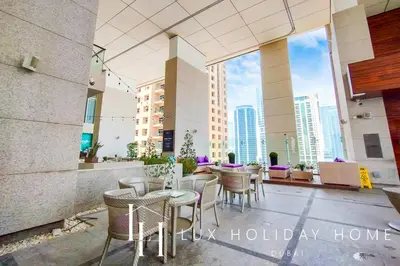 a patio with tables and chairs in a building at LUX The Bonnington JLT Suite 2 in Dubai