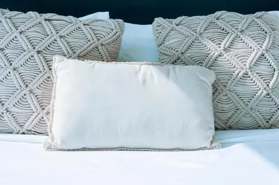 a white pillow sitting on top of a bed at WelHome - Opulent Retreat With Panoramic Cityscape Views in Dubai