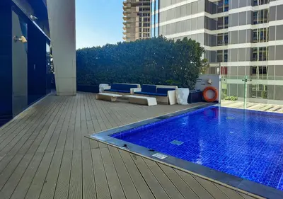 a swimming pool on a balcony of a building at WelHome - Opulent Retreat With Panoramic Cityscape Views in Dubai