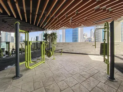 a gym with a view of the city at WelHome - Opulent Retreat With Panoramic Cityscape Views in Dubai