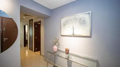 a hallway with a picture of a tree on the wall at Burj and fountain view 3BHK Near Dubai Mall in Dubai