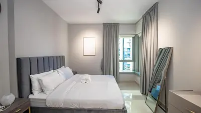 a bedroom with a bed with a teddy bear on it at Burj and fountain view 3BHK Near Dubai Mall in Dubai