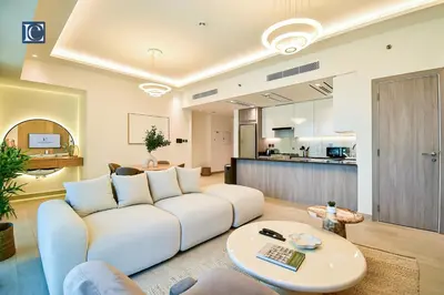 a living room with a white couch and a table at Luxury Escapes - ME DO RE Tower JLT in Dubai