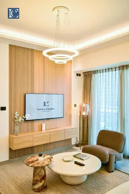 a living room with a table and a tv at Luxury Escapes - ME DO RE Tower JLT in Dubai