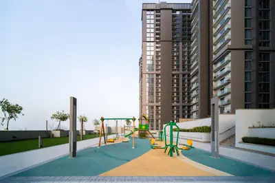 a playground in front of a tall building at SettlerHomes - Serene Downtown Stay on the High-Floor in Dubai