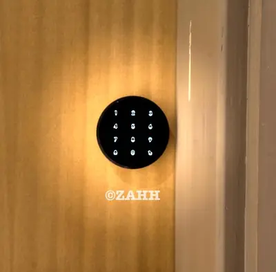 a black alarm clock on a wooden door at Business Bay Retreat in Dubai