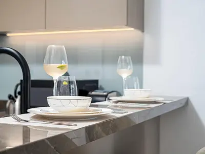 a table with two glasses of white wine on it at Exceptional 1Bedroom with Premium Amenities in Dubai