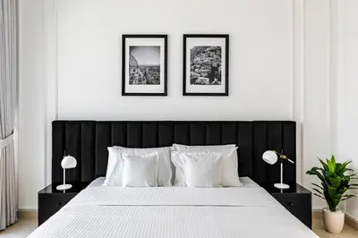 a bedroom with a black and white bed with two lamps at 2BR City View Bay Square B13 in Dubai
