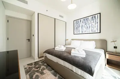 a bedroom with a bed with two towels on it at SettlerHomes - Emaar Beachfront Haven With The Sea View in Dubai