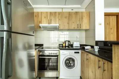 a kitchen with a dishwasher and a washer at ShoresInn - Stylish Space in Dubai Marina in Dubai