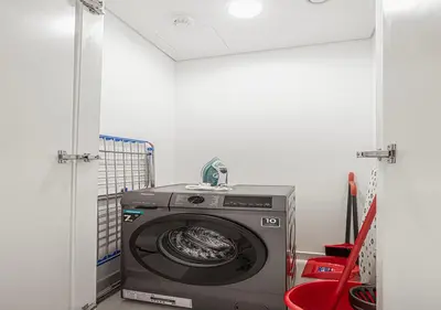 a washer and dryer in a room at Stylish Flat in Downtown Dubai with PS5 Gym and Pool in Dubai