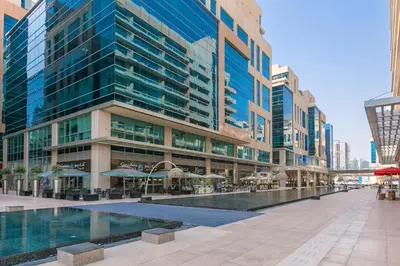 a large building with a pool in front of it at 1BR with Study City View in Bay Square B13 in Dubai