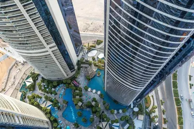 an aerial view of a resort with two tall buildings at Dubai Paramount 1BR APT Burj Khalifa view in Dubai