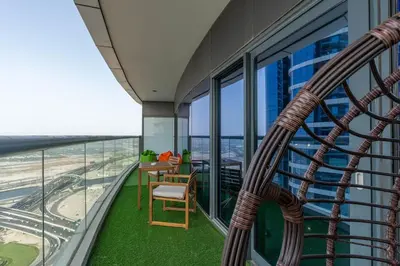 a balcony with a table and chair on a building at Dubai Paramount 1BR APT Burj Khalifa view in Dubai