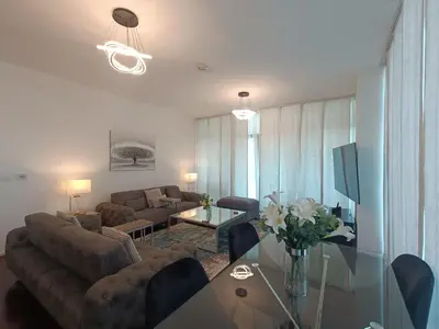 a living room with a couch and a table at Quill Residence - Canal View Spacious 3 bedroom Apartment in Dubai