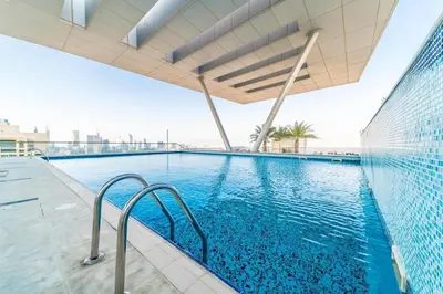 a swimming pool on top of a building at Quill Residence - Canal View Spacious 3 bedroom Apartment in Dubai