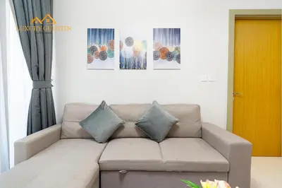 a living room with a couch with pillows on it at Elegant 2-BR with Canal & City Views Pool Amenities in Dubai