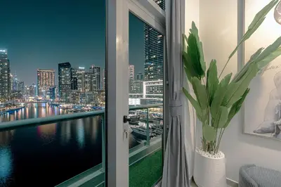 a window with a view of a city skyline at A Marina Luxe Retreat in Dubai