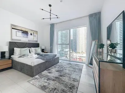 a bedroom with a bed and a large window at La Vie JBR Gorgeous One Bedroom Beach Access Panoramic Pool in Dubai