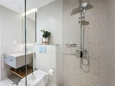 a bathroom with a shower with a toilet and a sink at La Vie JBR Gorgeous One Bedroom Beach Access Panoramic Pool in Dubai