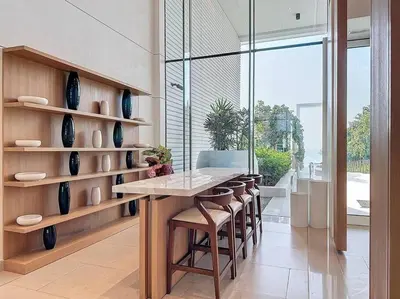 a dining room with a table and some vases at La Vie JBR Gorgeous One Bedroom Beach Access Panoramic Pool in Dubai