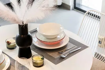 a table with a bowl and a vase on a table at Executive Residence-Dubai Hills by Serenity Living in Dubai