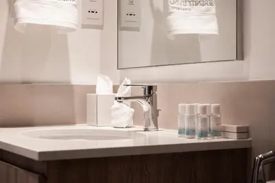 a bathroom counter with a sink and a mirror at Executive Residence-Dubai Hills by Serenity Living in Dubai