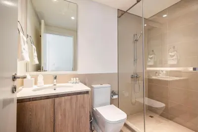 a bathroom with a toilet and a sink and a shower at Executive Residence-Dubai Hills by Serenity Living in Dubai