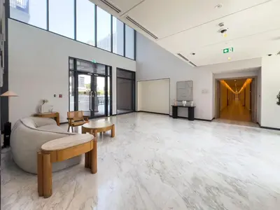 a large room with a couch and tables and windows at Executive Residence-Dubai Hills by Serenity Living in Dubai