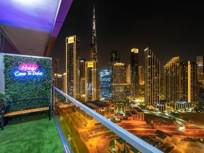 a view of a city skyline at night at 5 Star High Rise Luxury Apartment, Infinity Pool With Stunning Burj View - Brand New Apartment in Dubai