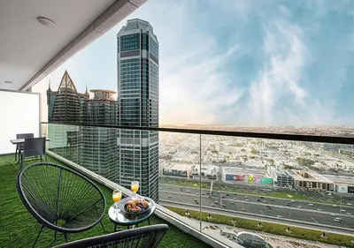 a balcony with a view of a city at 5 Star High Rise Luxury Apartment, Infinity Pool With Stunning Burj View - Brand New Apartment in Dubai