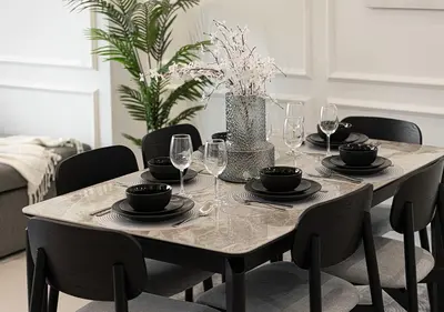 a dining room table with plates and wine glasses at 5 Star High Rise Luxury Apartment, Infinity Pool With Stunning Burj View - Brand New Apartment in Dubai