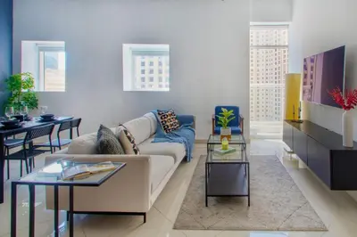 a living room with a couch and a table at ShoresInn - Elegant 2BR with Dubai Marina View in Dubai