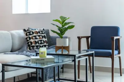a living room with two glass tables and a couch at ShoresInn - Elegant 2BR with Dubai Marina View in Dubai