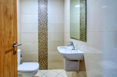 a bathroom with a sink and a toilet and a mirror at ShoresInn - Elegant 2BR with Dubai Marina View in Dubai