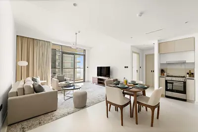 a kitchen and living room with a table and chairs at Silkhaus 1BDR Marina Vista with Private Beach Access in Dubai