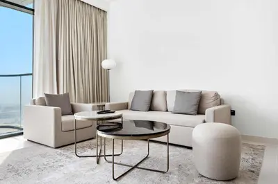 a living room with a couch and a table at Silkhaus 1BDR Sea View Retreat with Private Beach in Dubai
