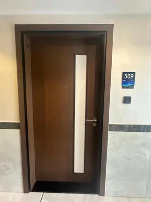 a door in a building with a sign on it at Peaceful Studio Getaway in Liwan in Dubai