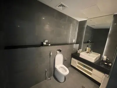 a bathroom with a toilet and a sink at Damac canal views building in Dubai