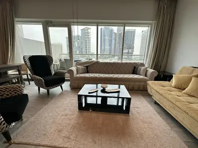 a living room with a couch and a coffee table at Damac canal views building in Dubai
