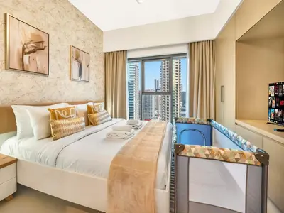 a bedroom with a large bed with a large window at Luxury 1BR, 5 Min walk to Dubai Mall & Burj Khalifa, Can Sleep 1-4 in Dubai