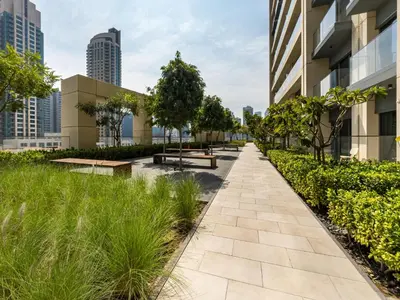 a walkway in the city with buildings at Luxury 1BR, 5 Min walk to Dubai Mall & Burj Khalifa, Can Sleep 1-4 in Dubai