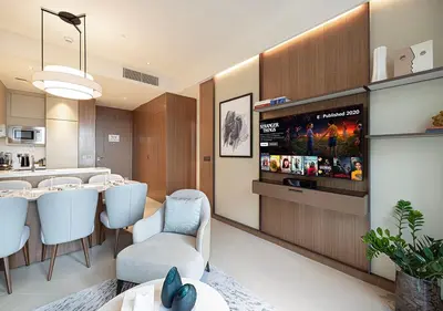 a dining room with a table and white chairs at Luxurious 2BR at Address Opera with Boulevard Views in Dubai