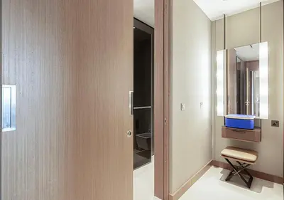 a bathroom with a mirror and a chair in it at Luxurious 2BR at Address Opera with Boulevard Views in Dubai
