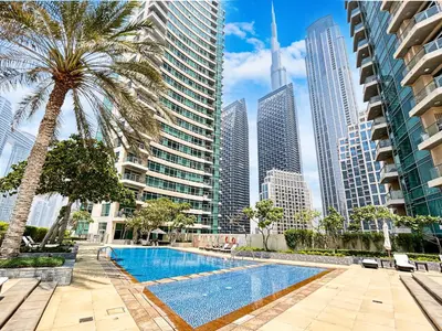 a swimming pool in the middle of a city with tall buildings at Elegant & Cozy 2BR Home in the Heart of Downtown in Dubai
