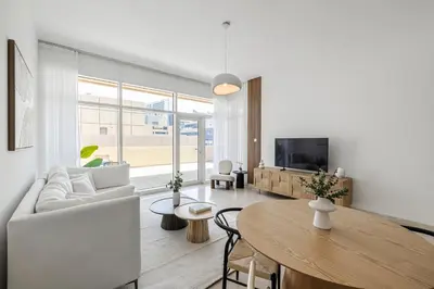 a living room with a couch and a table at 1BR with Study City View Bay Square in Dubai